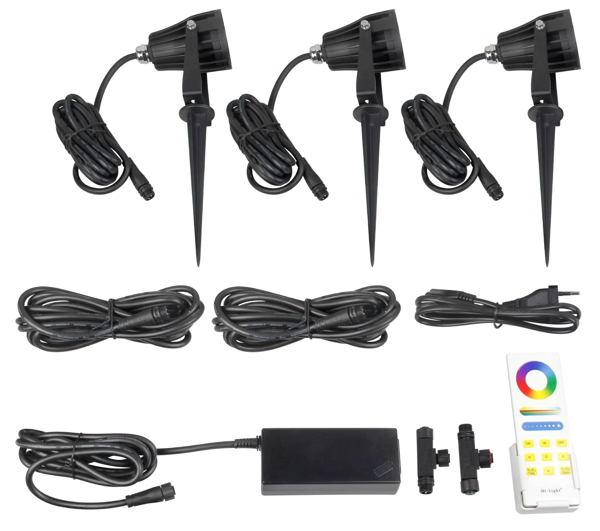 AuraLed Smart Garden Spotlight Kit contents laid flat, including three black spike-mounted spotlights with cables, a power supply unit, connectors, and an RF colour remote control